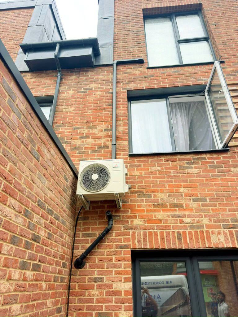 AC condenser on wall brackets on a townhouse – Airhive UK